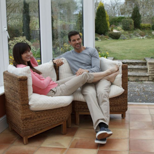 couple sitting on jepara corner sofa