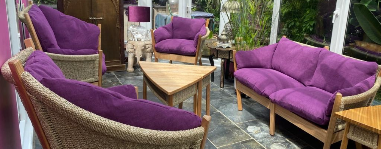 purple cushioned sofa and chair set with tables