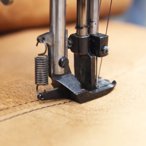 Closeup,Of,Sewing,Machine,Working,Part,With,Leather