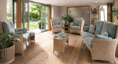 Jogya furniture arranged in an airy living area with bifold door access to gardens